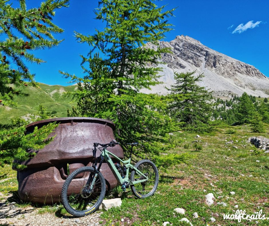 Mountain bike beside a historic Italian military bunker turret in Bardonecchia