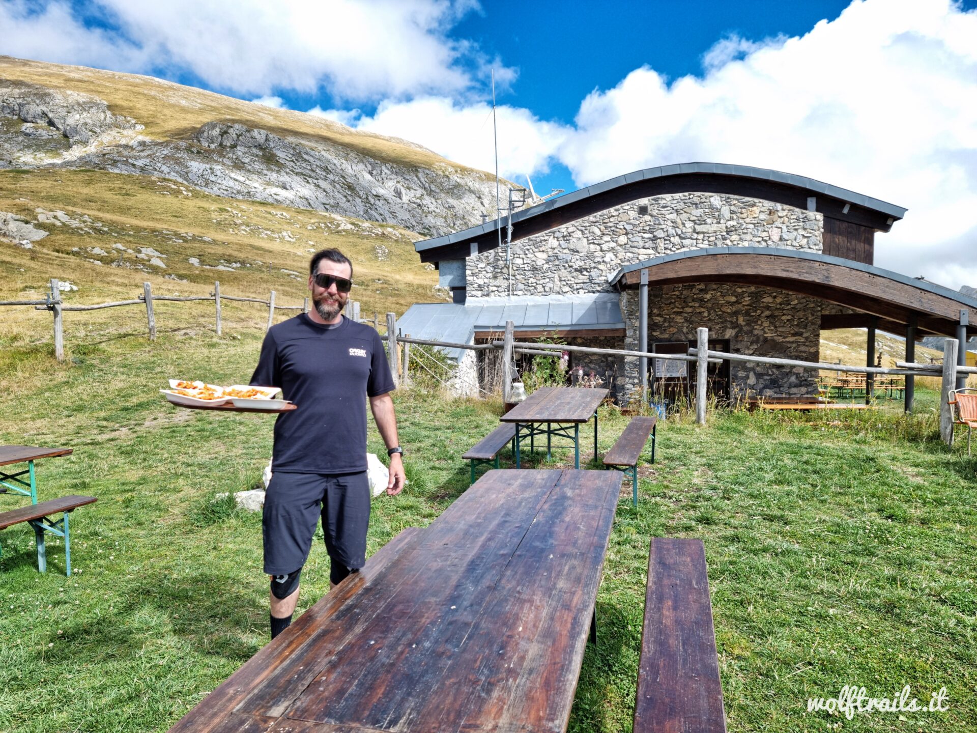 Roberto Maselli WolfTrails owner and guide serving some Pasta at Rifugio Don Barbera