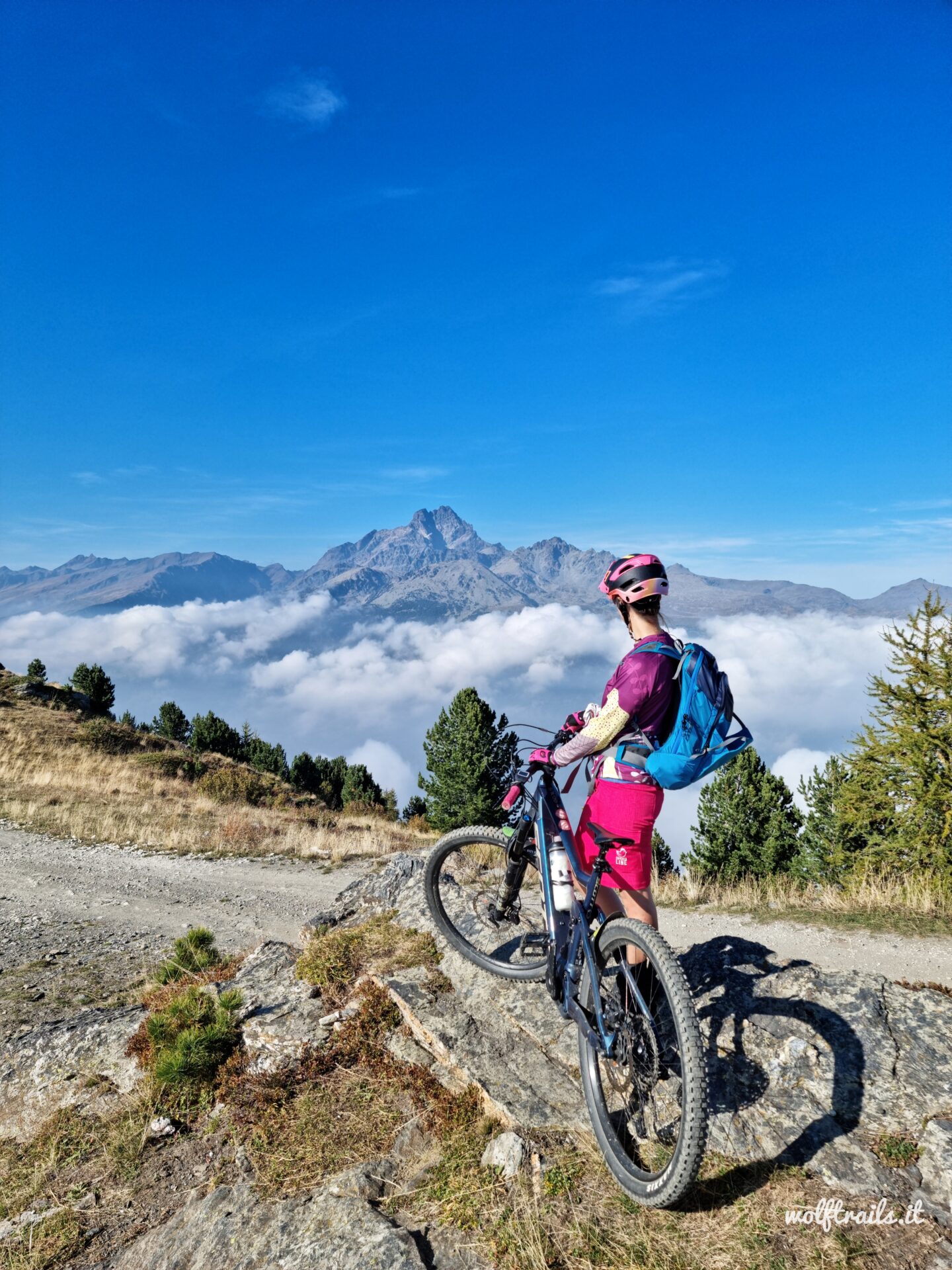 mountain biker overlooking Monviso from Strada dei Cannoni near Colle di Sampeyre