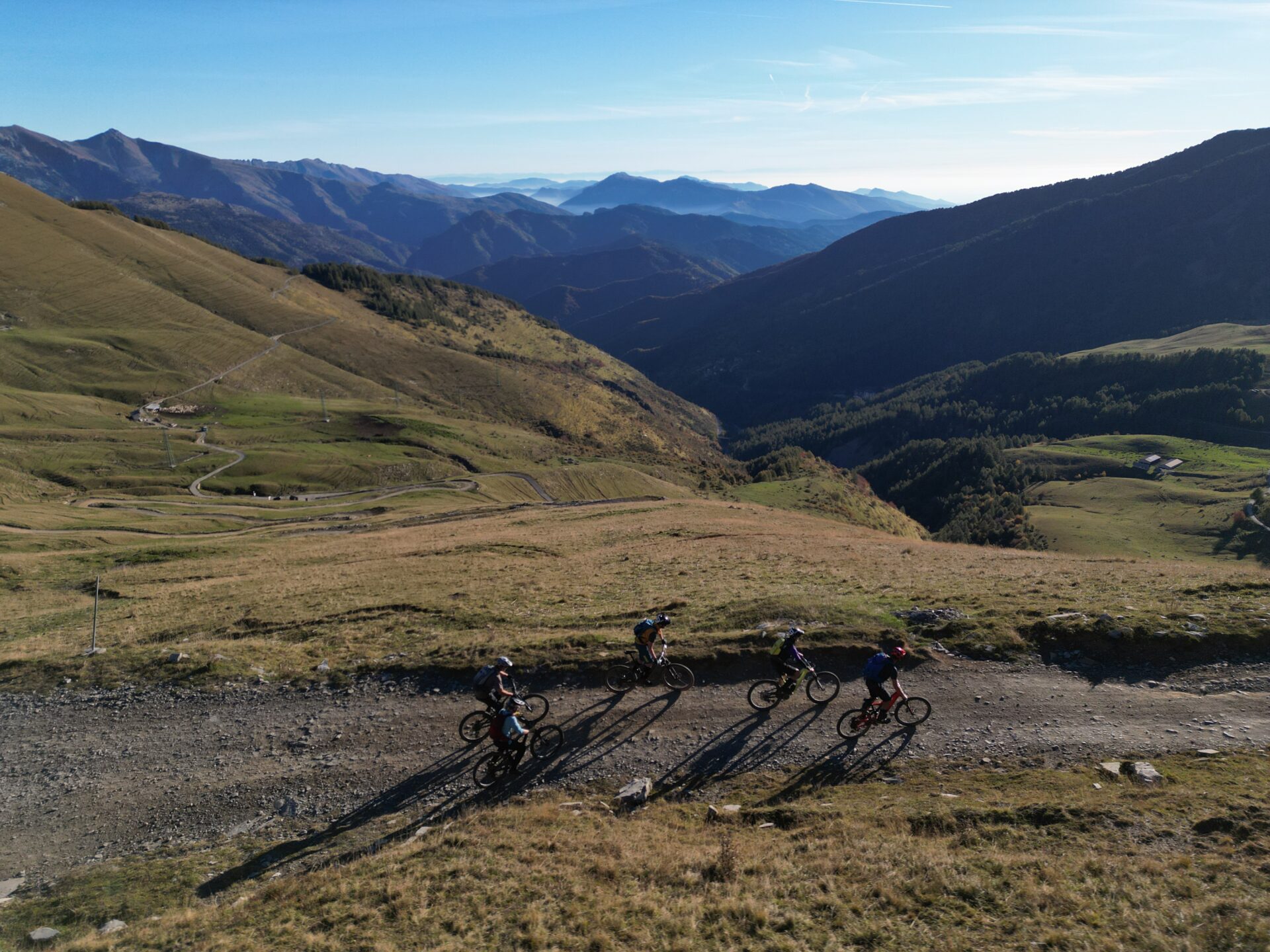 Guided MTB group riding high-altitude mountain route in the Italian Alps
